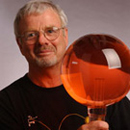 Hank Ryan is holding a glass globe full of red liquid in his portrait.